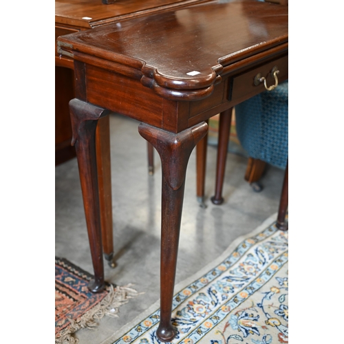 282 - A Victorian mahogany lobed corner fold over card table, with twin gate-legs and frieze drawer, raise... 