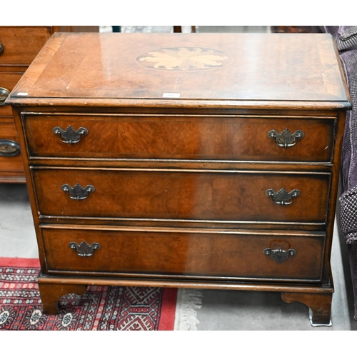 293 - A reproduction cross-banded yew chest of three  drawers with inlaid top, on shaped bracket feet, 79 ... 