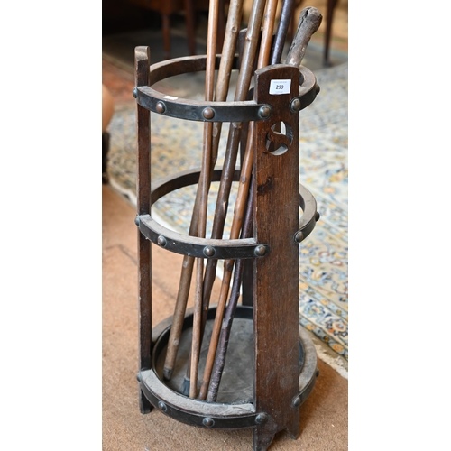 299 - An Arts & Crafts circular tapering open stick stand to/with sticks, 30 cm dia. x 73 cm h