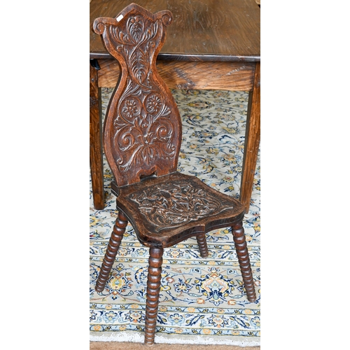 359 - An antique oak hall chair, with carved and moulded back and seat