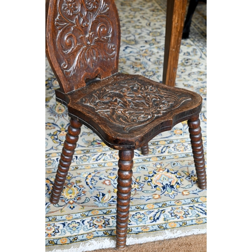 359 - An antique oak hall chair, with carved and moulded back and seat