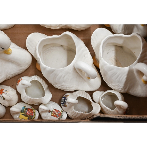 371 - A graduated collection of nine Dartmouth pottery swan-vases to/w ten crested china swans (box)