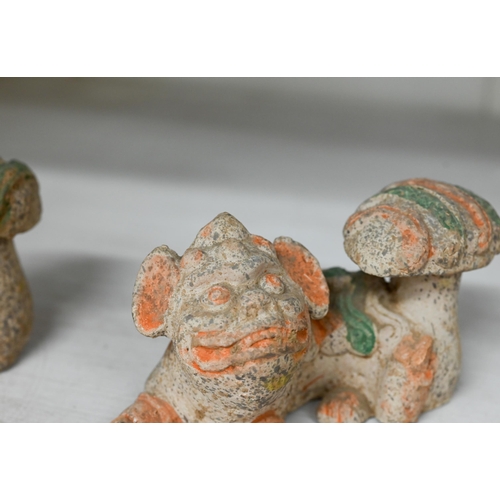 408 - A pair of Chinese earthenware reclining kylin with vestigial painting, 7.5 x 12 cm