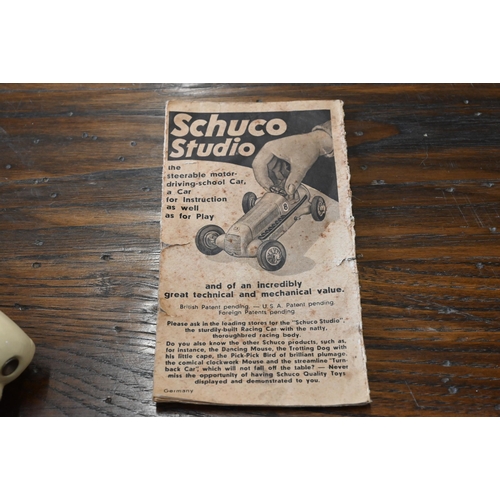 423 - A Schuco Studio clockwork racing car with four spare wheels and accompanying leaflet to/w a Schuco E... 