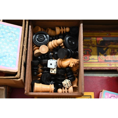 438 - A set of turned and carved wood chessmen and draughts, bone and ebony dominos and various vintage bo... 