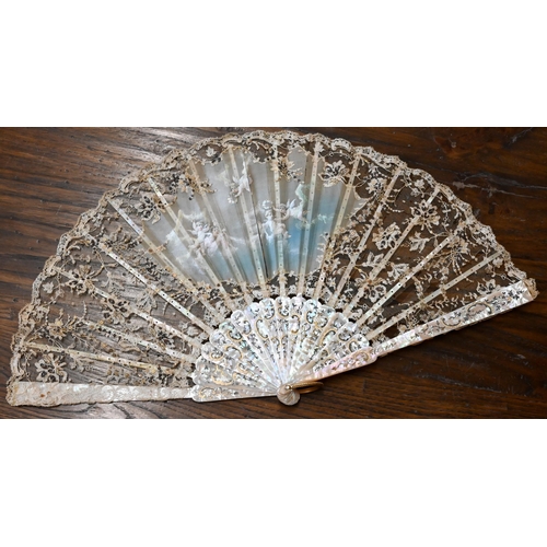 447 - An antique lace gauze fan, the central panel painted with cherubs, on decorated mother of pearl stic... 