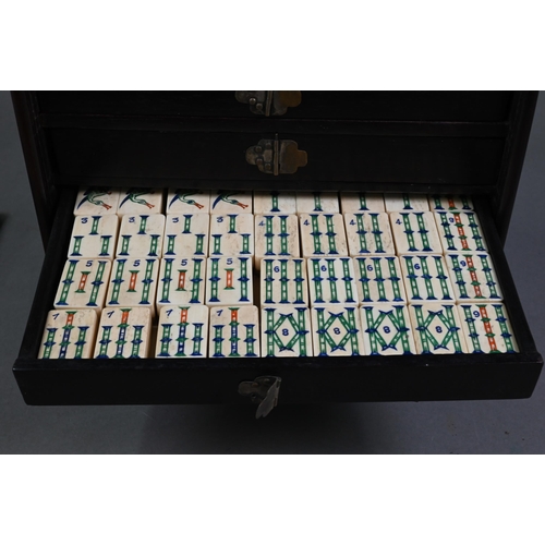 451 - An antique Chinese Mah Jong set with bone and bamboo tiles, in rosewood case with five drawers