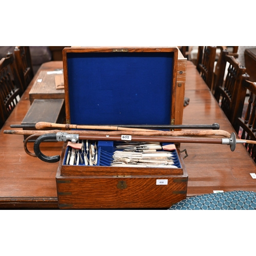 458 - An antique brass-bound oak canteen by Army & Navy, containing a mixed selection of Victorian and... 