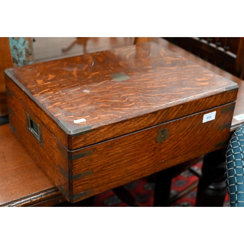 458 - An antique brass-bound oak canteen by Army & Navy, containing a mixed selection of Victorian and... 