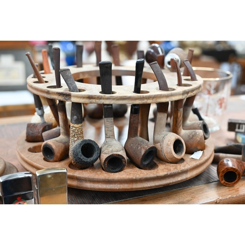 460 - A revolving wooden pipe-rack to/w various pipes, lighters etc