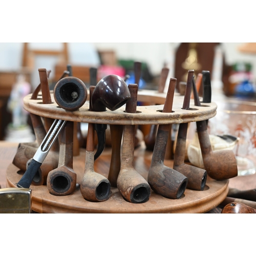 460 - A revolving wooden pipe-rack to/w various pipes, lighters etc