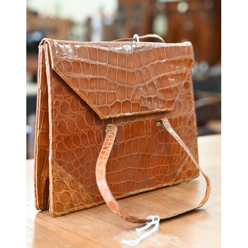 466A - A vintage brown crocodile leather handbag with slender short handles and popper fastener, 22 x 17 cm