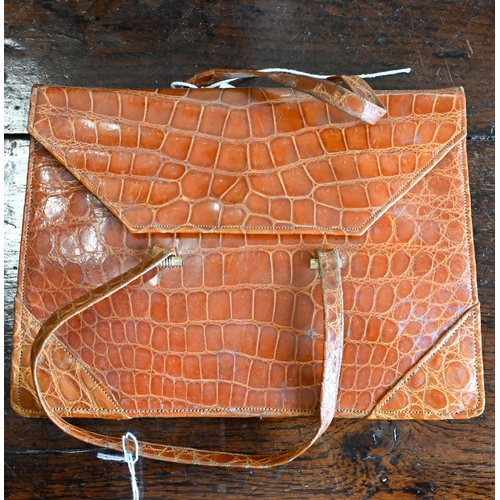 466A - A vintage brown crocodile leather handbag with slender short handles and popper fastener, 22 x 17 cm