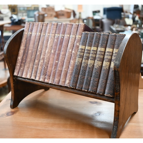 506 - An oak book trough containing twelve volumes of Shakespeare's works 1883-86, in gilt decorative Moro... 