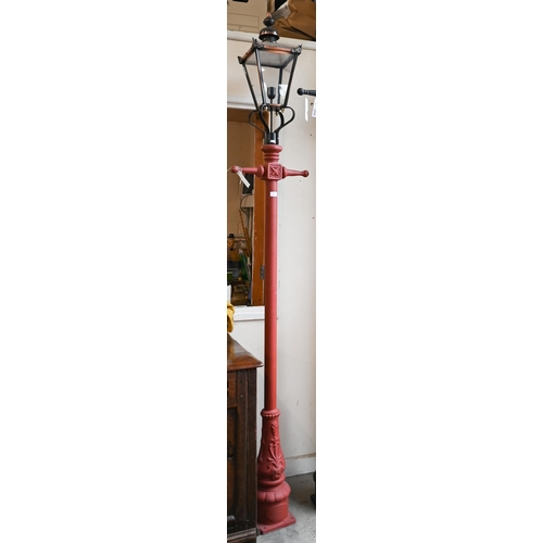 515 - A Victorian-style red cast iron-effect streetlamp post with copper four-glass lantern, approx 240 cm... 