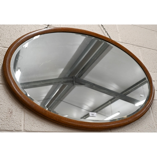 521 - # An Edwardian mirror with bevelled oval plate and inlaid walnut frame, 94 cm wide x 65 cm wide