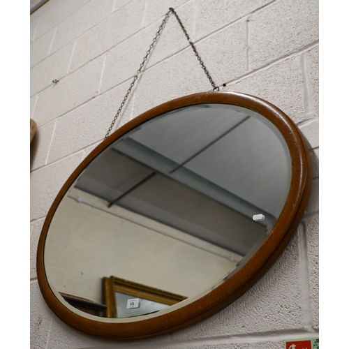 521 - # An Edwardian mirror with bevelled oval plate and inlaid walnut frame, 94 cm wide x 65 cm wide