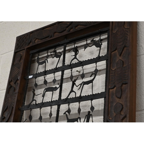 523 - An African style decorative frame with artisan steel panel