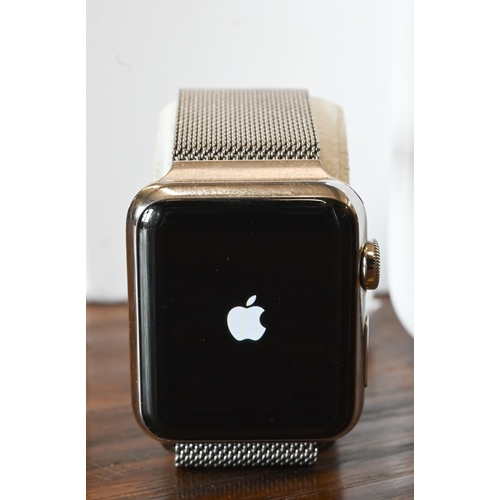 62 - An Apple Series 3 wristwatch, magnetic stainless band, boxed with charge cable, usb plug and booklet... 