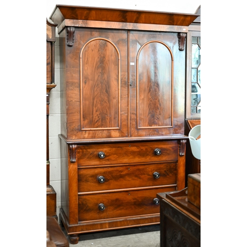 68 - A 19th century mahogany linen press (slides removed and replaced with two brass rails), with arch pa... 