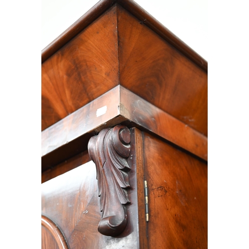 68 - A 19th century mahogany linen press (slides removed and replaced with two brass rails), with arch pa... 