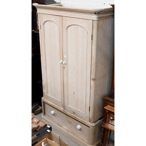 72 - A pine wardrobe with arch panelled doors and single drawer to base a/f, 120 x 56 x 204 cm high