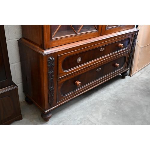 80 - A 19th century mahogany bookcase on two drawer chest base, the astragal glazed doors enclosing adjus... 