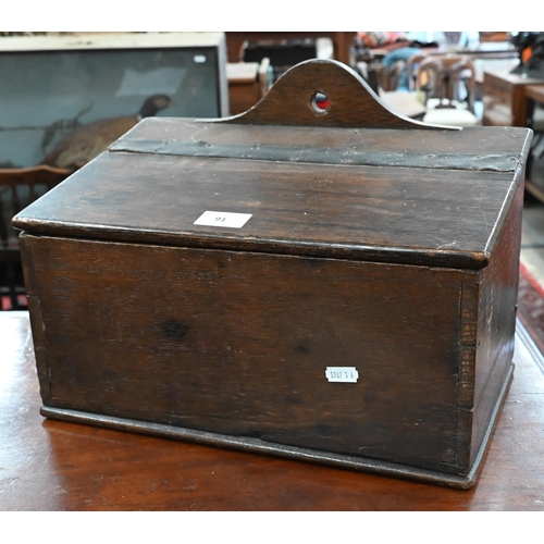 91 - An antique oak slopetop candle box, 38 x 22 x 28 cm high to/w an antique wooden pipe-rack carved wit... 