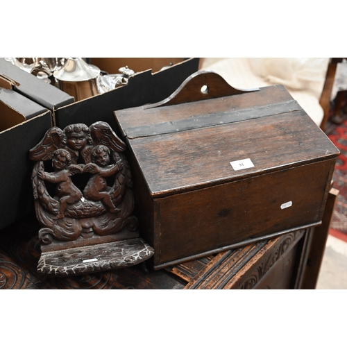 91 - An antique oak slopetop candle box, 38 x 22 x 28 cm high to/w an antique wooden pipe-rack carved wit... 