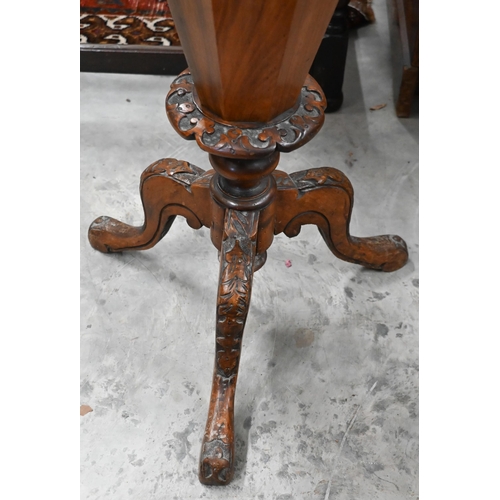 93 - A Victorian octagonal walnut sewing table with carved tripod base, 42 cm diam x 70 cm high