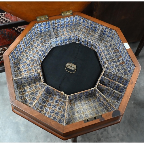 93 - A Victorian octagonal walnut sewing table with carved tripod base, 42 cm diam x 70 cm high