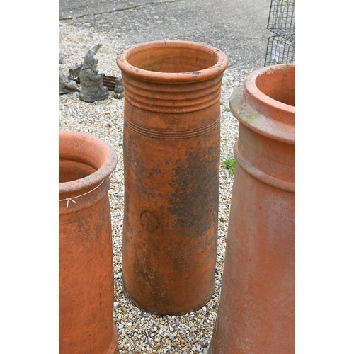 14 - A trio of tall cylindrical reclaimed and weathered terracotta chimney pots, 92 cm; 82 cm and 71 cm h... 