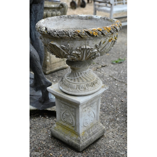 2 - A pair of weathered cast stone classical urns decorated with acanthus, raised on square plinths, 88 ... 