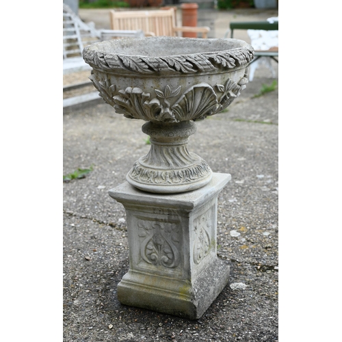 2 - A pair of weathered cast stone classical urns decorated with acanthus, raised on square plinths, 88 ... 