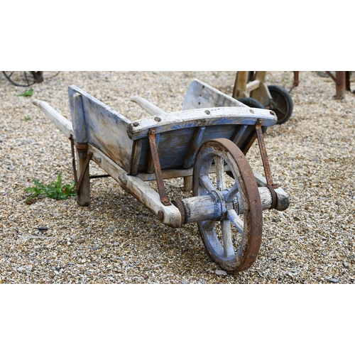 23 - A weathered vintage wooden wheelbarrow