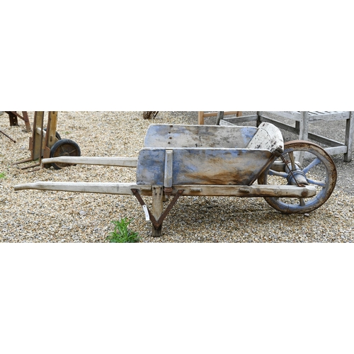 23 - A weathered vintage wooden wheelbarrow