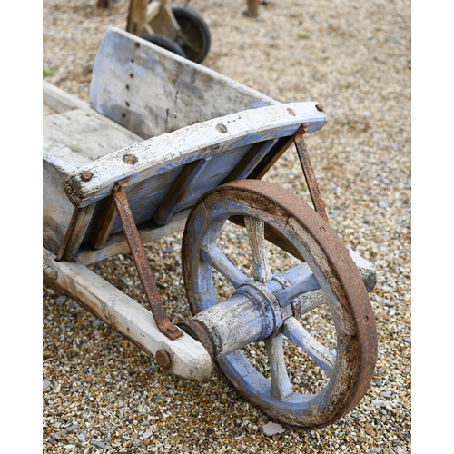 23 - A weathered vintage wooden wheelbarrow