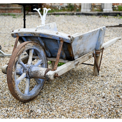 23 - A weathered vintage wooden wheelbarrow