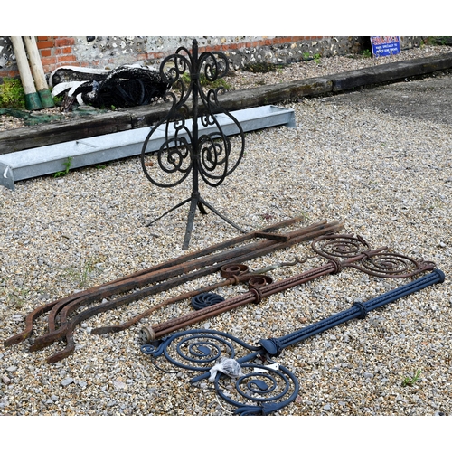 24 - Two differing ornate wrought iron garden lighting frames/stands with butterflied spiral finials - bo... 