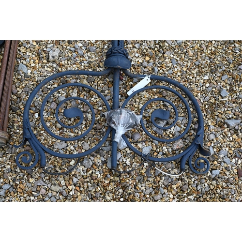 24 - Two differing ornate wrought iron garden lighting frames/stands with butterflied spiral finials - bo... 