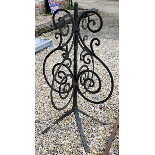 24 - Two differing ornate wrought iron garden lighting frames/stands with butterflied spiral finials - bo... 