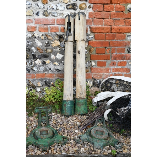 27 - A vintage Slazengers Ltd tennis court set comprising a pair of cast iron post mounts, two adjustable... 