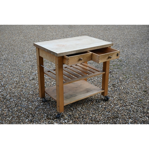 347 - A traditional beech kitchen island trolley unit, with two frieze drawers over two wicker baskets and... 