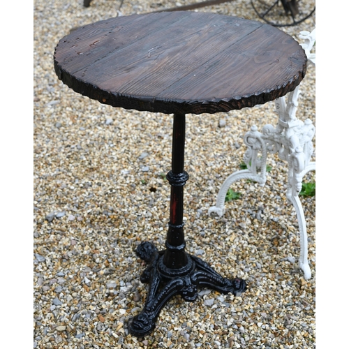 41 - A traditional circular wooden top table to/with a Victorian style cast iron tripod table base, both ... 