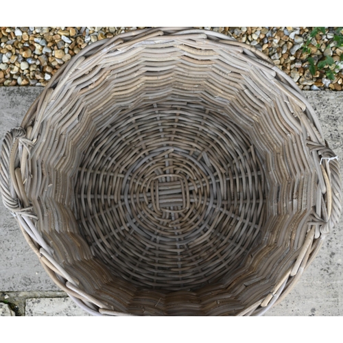 45 - A 'giant' wicker log basket with twin loop handles, 63 cm dia. x 51 cm h, new old-stock