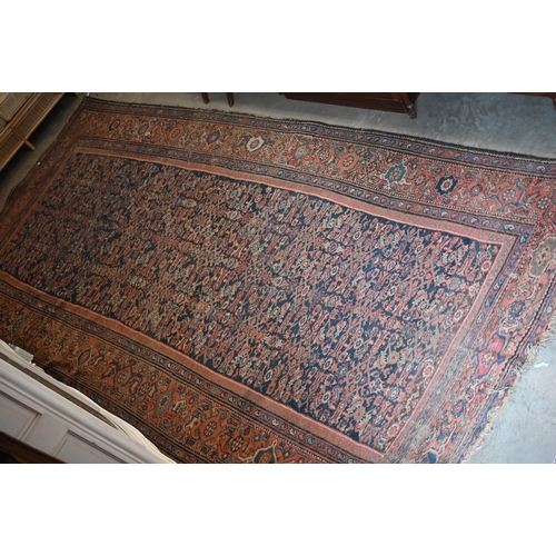 116 - A worn Persian Hamadan kelleigh carpet, Herati design on navy blue ground with terracotta border, 40... 