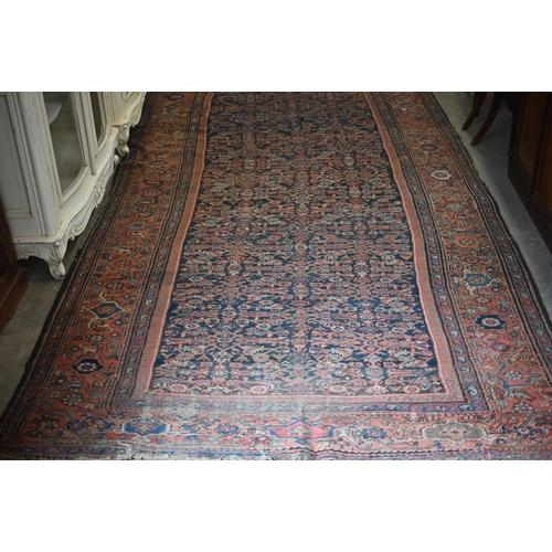 116 - A worn Persian Hamadan kelleigh carpet, Herati design on navy blue ground with terracotta border, 40... 