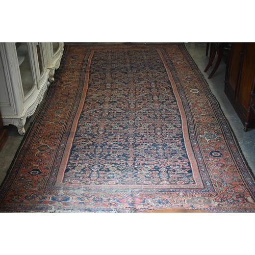 116 - A worn Persian Hamadan kelleigh carpet, Herati design on navy blue ground with terracotta border, 40... 