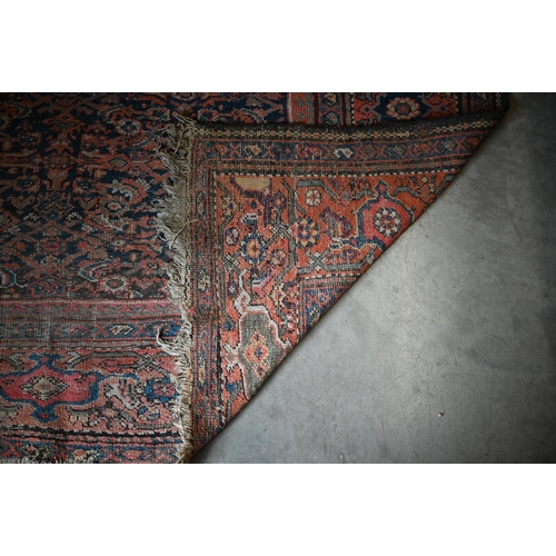 116 - A worn Persian Hamadan kelleigh carpet, Herati design on navy blue ground with terracotta border, 40... 