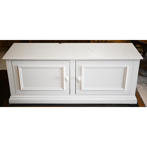 222 - A white painted twin door low cabinet, on a plinth base, 120 cm x 38 cm x 47 cm h